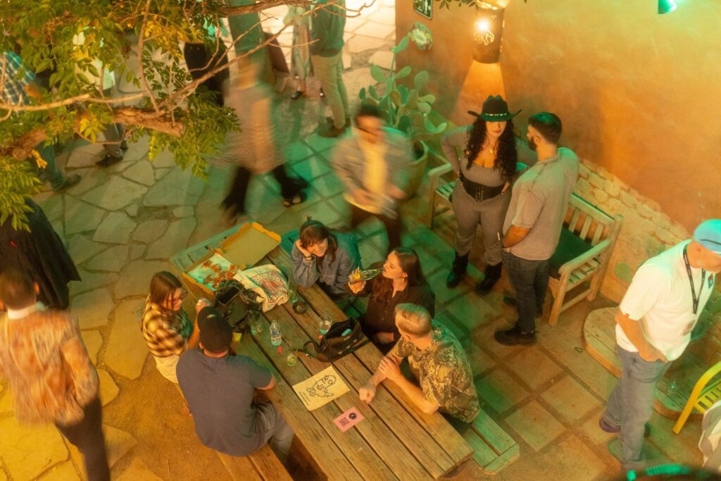 Attendees gathering in the Art Blocks backyard during Art Blocks Marfa Weekend in Marfa, Texas